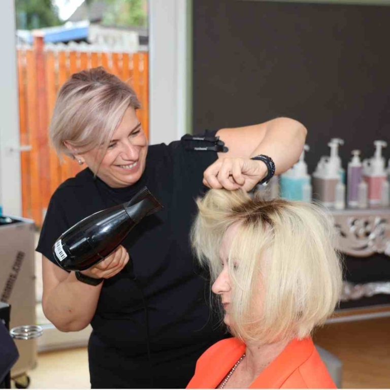 A woman gets hair her done in a Hairdreams partner salon