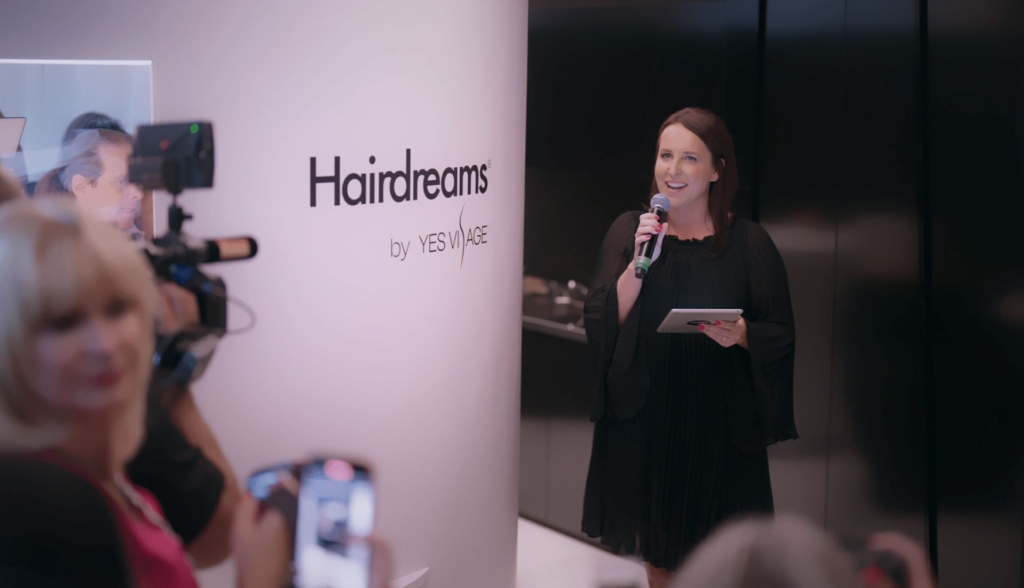 Woman speaks with microphone to the audience