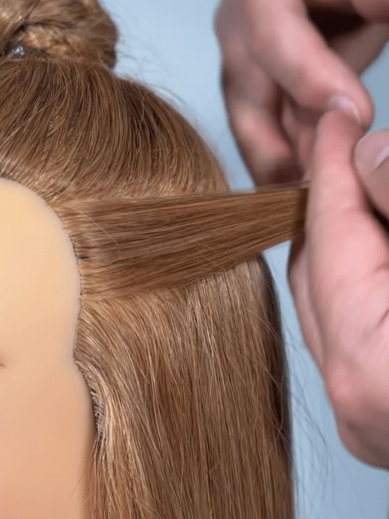 A hairdresser shows that the hair extension with Mini Micros is absolutely invisible.